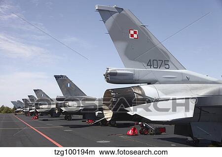 A row of F-16 jets from the Polish and Greek Air Forces, Albacete Air Base, Spain. View Large Photo Image Picture - A row of F-16 jets from the Polish and Greek Air Forces, Albacete Air Base, Spain.. Fotosearch