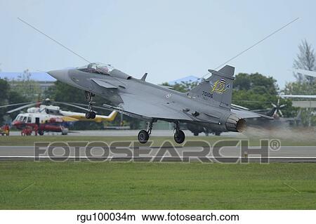 A Saab JAS 39 Gripen C of the Royal Thai Air Force taking off. View Large Photo Image Picture - A Saab JAS 39 Gripen C of the Royal Thai Air Force taking off.. Fotosearch