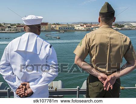 A Sailor and Marine man the rails aboard USS Boxer. View Large Photo Image Picture - A Sailor and Marine man the rails aboard USS Boxer.. Fotosearch