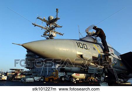 A Sailor cleans the canopy of an F-14D Tomcat. View Large Photo Image Picture - A Sailor cleans the canopy of an F-14D Tomcat.. Fotosearch