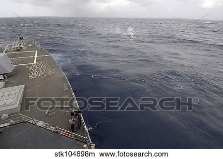 A sailor fires a. 50-caliber machine gun aboard guided missile destroyer USS Nitze. View Large Photo Image Picture - A sailor fires a. 50-caliber machine gun aboard guided missile destroyer USS Nitze.. Fotosearch