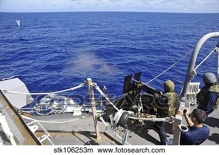A Sailor fires a. 50 caliber machine gun aboard USS McCampbell. View Large Photo Image Picture - A Sailor fires a. 50 caliber machine gun aboard USS McCampbell.. Fotosearch