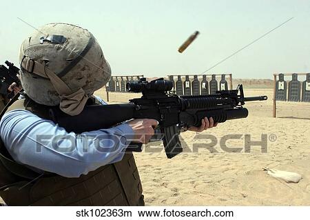 A Sailor fires a weapon. View Large Photo Image Picture - A Sailor fires a weapon.. Fotosearch