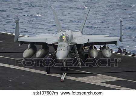 A sailor refuels an F/A-18E Super Hornet. View Large Photo Image Picture - A sailor refuels an F/A-18E Super Hornet.. Fotosearch
