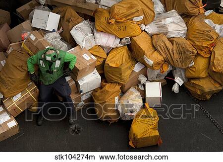 A Sailor waits to move mail below decks. View Large Photo Image Picture - A Sailor waits to move mail below decks.. Fotosearch