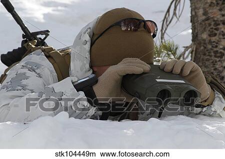 A scout sniper watches to see any position changes in his target. View Large Photo Image Picture - A scout sniper watches to see any position changes in his target.. Fotosearch