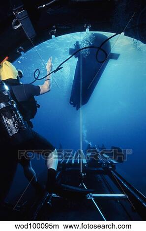 A SEAL Delivery Vehicle breaks away from the Dry Deck Shelter on a submarine. View Large Photo Image Picture - A SEAL Delivery Vehicle breaks away from the Dry Deck Shelter on a submarine.. Fotosearch