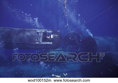 A SEAL Delivery Vehicle on tether connected to the dry deck shelter on USS Kamehameha. View Large Photo Image Picture - A SEAL Delivery Vehicle on tether connected to the dry deck shelter on USS Kamehameha.. Fotosearch