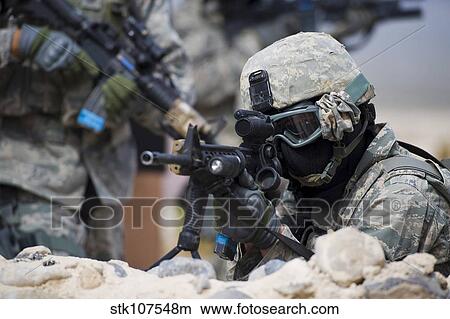 A security forces Airman provides cover for his squad. View Large Photo Image Picture - A security forces Airman provides cover for his squad.. Fotosearch
