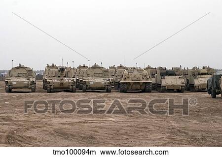 A selection of M992 C. A. T or Carrier Ammunition Tracked vehicles line up during a deployment. View Large Photo Image Picture - A selection of M992 C. A. T or Carrier Ammunition Tracked vehicles line up during a deployment.. Fotosearch