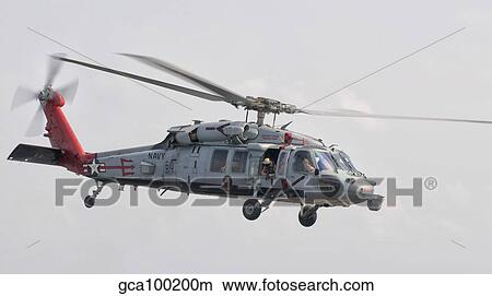 A SH-60 helicopter in flight over the Persian Gulf. View Large Photo Image Picture - A SH-60 helicopter in flight over the Persian Gulf.. Fotosearch
