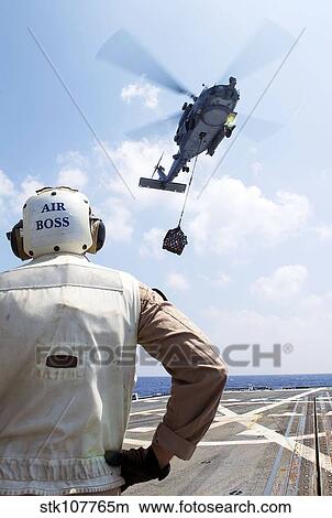 A SH-60 R Seahawk prepares to drop supplies. View Large Photo Image Picture - A SH-60 R Seahawk prepares to drop supplies.. Fotosearch