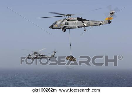 A SH-60J Seahawk and a MH-60S during a vertical replenishment. View Large Photo Image Picture - A SH-60J Seahawk and a MH-60S during a vertical replenishment.. Fotosearch