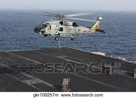 A SH-60J Seahawk conducts a vertical replenishment with USNS Supply. View Large Photo Image Picture - A SH-60J Seahawk conducts a vertical replenishment with USNS Supply.. Fotosearch