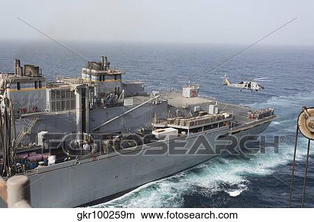 A SH-60J Seahawk conducts a vertical replenishment with USNS Supply. View Large Photo Image Picture - A SH-60J Seahawk conducts a vertical replenishment with USNS Supply.. Fotosearch