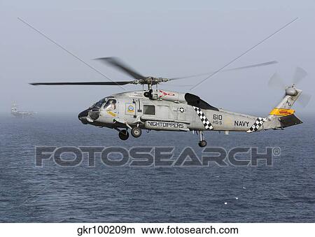A SH-60J Seahawk during a vertical replenishment in the Arabian Sea. View Large Photo Image Picture - A SH-60J Seahawk during a vertical replenishment in the Arabian Sea.. Fotosearch