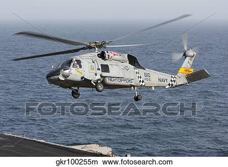 A SH-60J Seahawk during a vertical replenishment in the Arabian Sea. View Large Photo Image Picture - A SH-60J Seahawk during a vertical replenishment in the Arabian Sea.. Fotosearch