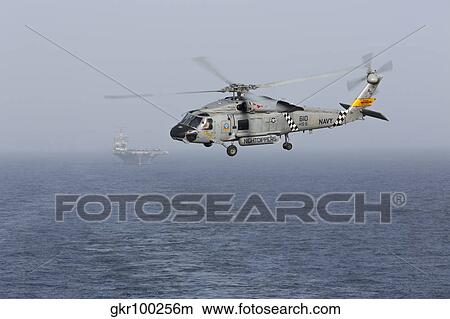 A SH-60J Seahawk during a vertical replenishment in the Arabian Sea. View Large Photo Image Picture - A SH-60J Seahawk during a vertical replenishment in the Arabian Sea.. Fotosearch