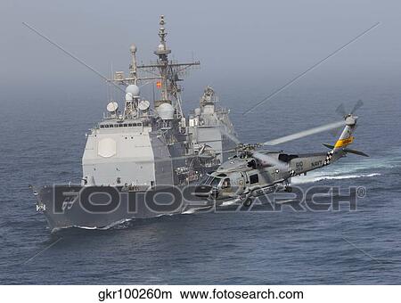 A SH-60J Seahawk flys by USS Vicksburg during a vertical replenishment. View Large Photo Image Picture - A SH-60J Seahawk flys by USS Vicksburg during a vertical replenishment.. Fotosearch