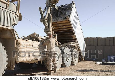 A shipping container is off-loaded from a logistics vehicle system. View Large Photo Image Picture - A shipping container is off-loaded from a logistics vehicle system.. Fotosearch