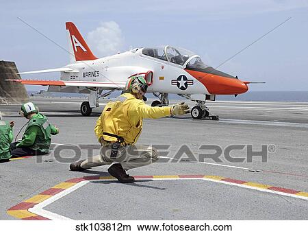 A shooter aboard the aircraft carrier USS George H. W. Bush launches a T-45C Goshawk training aircraft. View Large Photo Image Picture - A shooter aboard the aircraft carrier USS George H. W. Bush launches a T-45C Goshawk training aircraft.. Fotosearch
