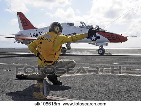 A shooter launches a T-45 Goshawk training aircraft. View Large Photo Image Picture - A shooter launches a T-45 Goshawk training aircraft.. Fotosearch
