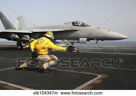 A shooter launches an F/A-18E Super Hornet from USS Dwight D Eisenhower. View Large Photo Image Picture - A shooter launches an F/A-18E Super Hornet from USS Dwight D Eisenhower.. Fotosearch