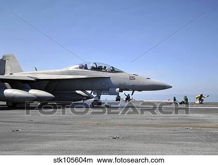 A shooter signals the launch of an F/A-18F Super Hornet. View Large Photo Image Picture - A shooter signals the launch of an F/A-18F Super Hornet.. Fotosearch