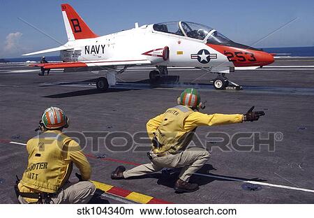 A shooter signlas the launch of a T-45A Goshawk trainer aircraft. View Large Photo Image Picture - A shooter signlas the launch of a T-45A Goshawk trainer aircraft.. Fotosearch