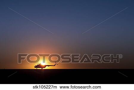 A Sikorsky S-61L Mk II helicopter taxis on the runway during sunrise. View Large Photo Image Picture - A Sikorsky S-61L Mk II helicopter taxis on the runway during sunrise.. Fotosearch