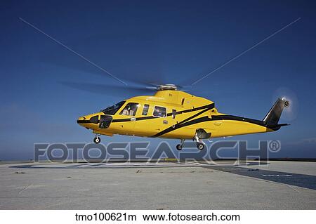 A Sikorsky S-76 utility helicopter taking off from an oil rig. View Large Photo Image Picture - A Sikorsky S-76 utility helicopter taking off from an oil rig.. Fotosearch