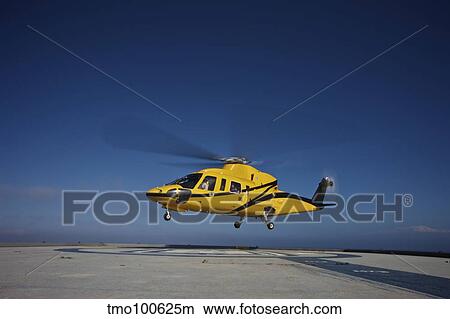 A Sikorsky S-76 utility helicopter taking off from an oil rig. View Large Photo Image Picture - A Sikorsky S-76 utility helicopter taking off from an oil rig.. Fotosearch