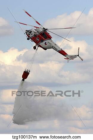 A Sokol W-3A helicopter of the Czech Air Force with a water bucket. View Large Photo Image Picture - A Sokol W-3A helicopter of the Czech Air Force with a water bucket.. Fotosearch
