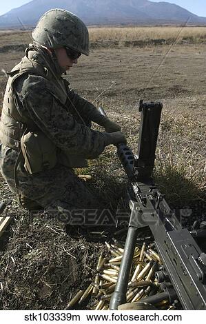 Picture - A soldier changes the barrel of an M2. 50 caliber machine gun.. Fotosearch