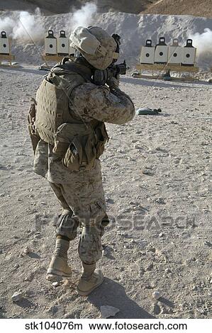 Picture - A soldier engages his target on a shooting range at Al Asad, Iraq.. Fotosearch