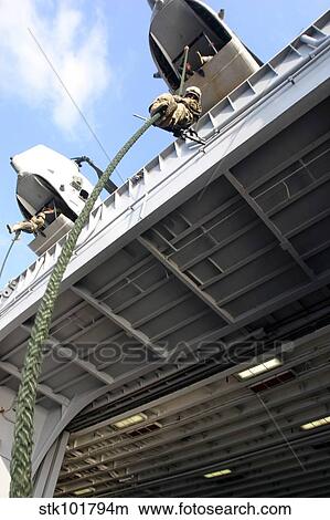Picture - A soldier fast-ropes from the rear of a CH-46E Sea Knight.. Fotosearch