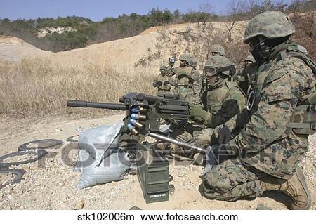 A soldier fires a MK19 40mm heavy machine gun. View Large Photo Image Picture - A soldier fires a MK19 40mm heavy machine gun.. Fotosearch