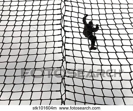 A soldier in training makes her way down the rope ladder at Victory Tower. View Large Photo Image Picture - A soldier in training makes her way down the rope ladder at Victory Tower.. Fotosearch