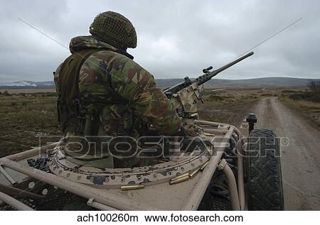 A soldier mans a. 50 caliber machine gun atop a Pink Panther Land Rover. View Large Photo Image Picture - A soldier mans a. 50 caliber machine gun atop a Pink Panther Land Rover.. Fotosearch