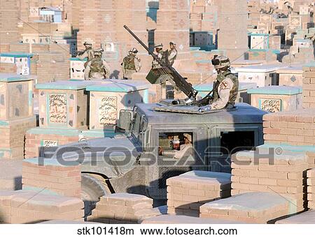 A soldier mans a M2. 50 caliber machine gun atop a humvee. View Large Photo Image Picture - A soldier mans a M2. 50 caliber machine gun atop a humvee.. Fotosearch