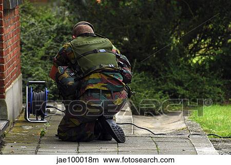 A soldier of the Belgian Army investigating a suspect building. View Large Photo Image Picture - A soldier of the Belgian Army investigating a suspect building.. Fotosearch