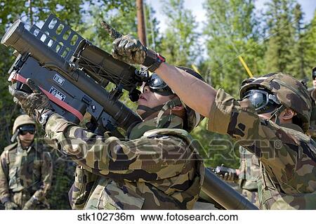 Picture - A soldier operates a missile launcher while his teammate locates the target.. Fotosearch