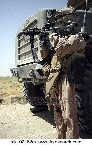 A soldier provides security for Marines. View Large Photo Image Picture - A soldier provides security for Marines.. Fotosearch