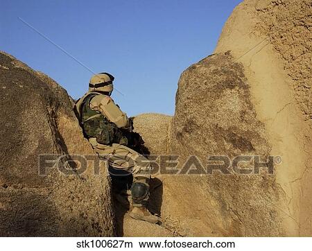 A soldier takes up a position during a security halt. View Large Photo Image Picture - A soldier takes up a position during a security halt.. Fotosearch