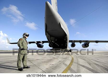 A soldier waits for his C-17 Globemaster III to launch. View Large Photo Image Picture - A soldier waits for his C-17 Globemaster III to launch.. Fotosearch