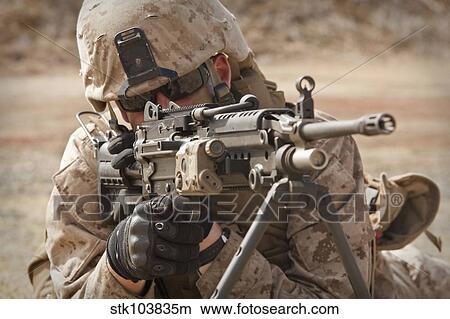 A squad automatic weapon gunner provides security. View Large Photo Image Picture - A squad automatic weapon gunner provides security.. Fotosearch