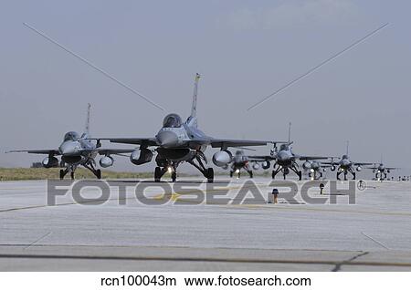 A squadron of Turkish Air Force F-16C and F-16D aircraft taxiing on the runway. View Large Photo Image Picture - A squadron of Turkish Air Force F-16C and F-16D aircraft taxiing on the runway.. Fotosearch