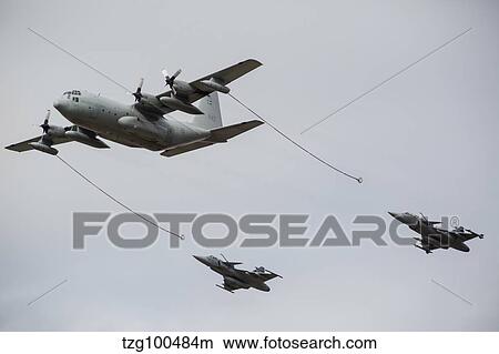 A Swedish Air Force C-130E Hercules with two Czech Air Force Gripens in tow. View Large Photo Image Picture - A Swedish Air Force C-130E Hercules with two Czech Air Force Gripens in tow.. Fotosearch