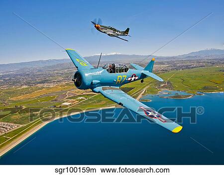 A T-6 Texan and P-51D Mustang in flight over Chino, California. View Large Photo Image Picture - A T-6 Texan and P-51D Mustang in flight over Chino, California.. Fotosearch