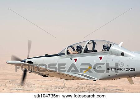 A T-6 Texan flying over Camp Speicher, Tikrit, Iraq. View Large Photo Image Picture - A T-6 Texan flying over Camp Speicher, Tikrit, Iraq.. Fotosearch
